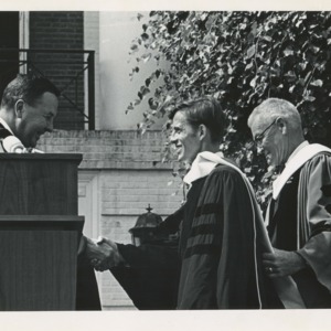 James Merrill receiving an honorary doctorate at Amherst College from Calvin H. Plimpton