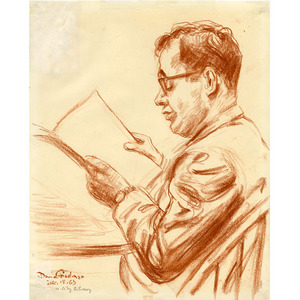 Man Wearing Glasses Reading At Table