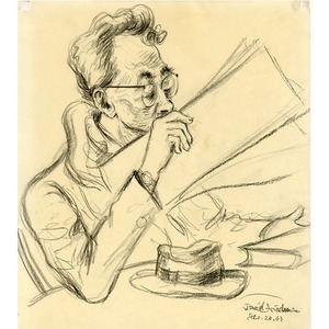 Man Wearing Glasses Reading Paper At Table